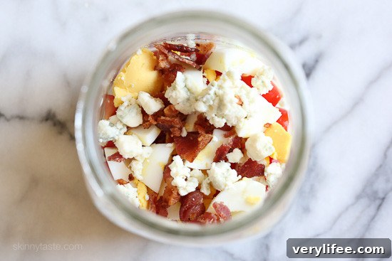 tomato, egg, cheese and bacon in mason jar