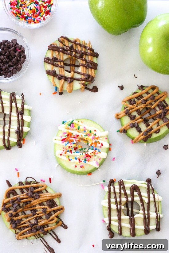 Apple Donuts Recipe: Cinnamon Ring Snacks for Kids 2 Donut-shaped apple snacks drizzled with chocolate and peanut butter