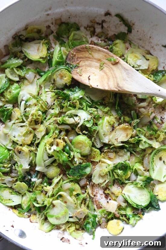Spiralized Parsnip Pasta with Sausage and Brussels Sprouts 7 Close-up of spiralized parsnips with spicy sausage and shredded Brussels sprouts.