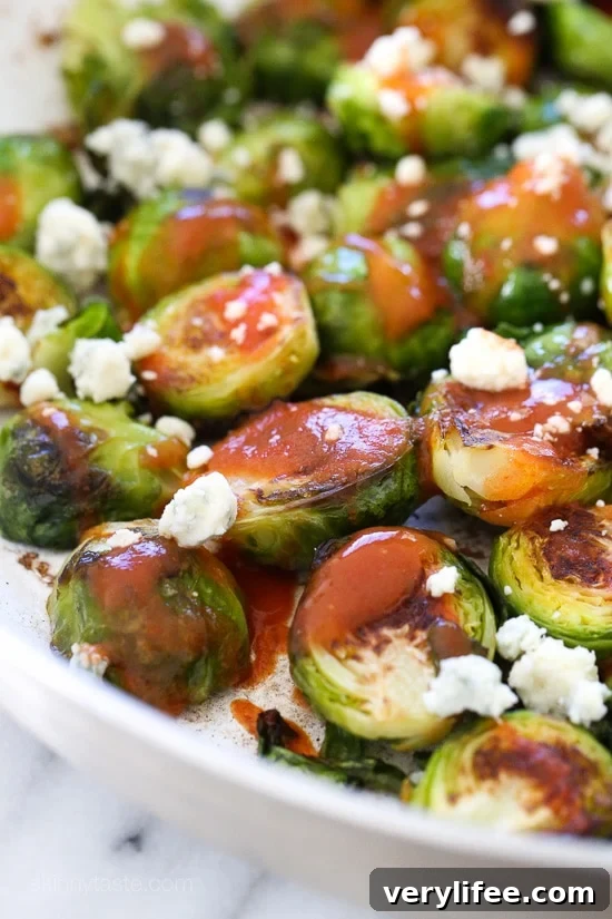These Brussels sprouts start in the skillet and finish in the oven for perfectly charred edges, then drizzled with buffalo hot sauce and crumbled blue cheese – SO good!!