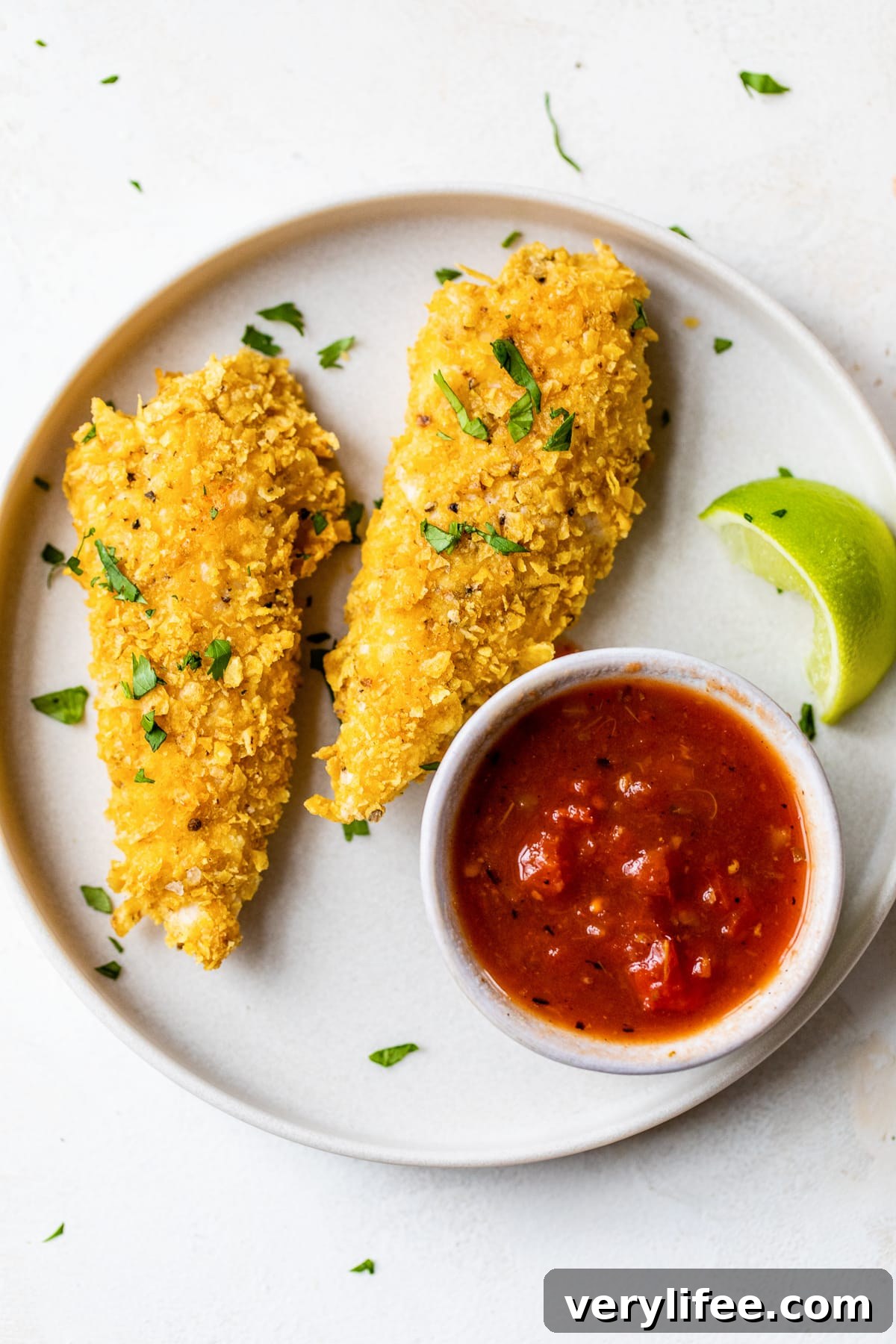 Crispy Tortilla-Crusted Chicken Tenders 2 Tortilla Encrusted Chicken Tenders with salsa