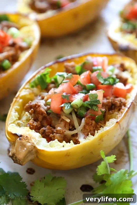 These Turkey Taco Spaghetti Squash Boats are filled with flavorful turkey taco meat, melted cheese and topped with pico de gallo.