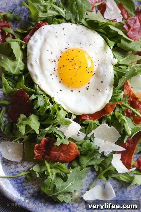 Crispy Prosciutto Arugula Salad with Parmesan and Fried Eggs 2 This easy salad has arugula, prosciutto, shaved Parmesan and a runny egg—pop the yolk for warm, silky dressing