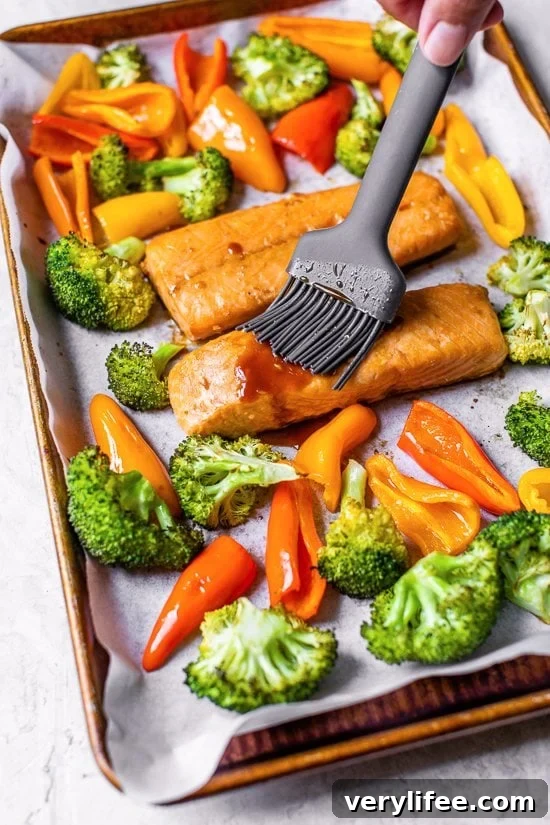 Sheet Pan Teriyaki Salmon with Roasted Vegetables 4 brushing teriyaki glaze on salmon