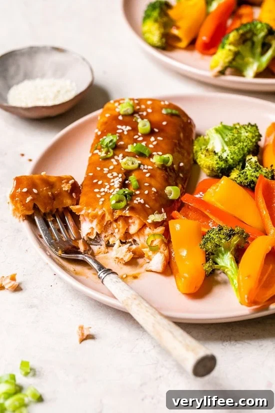 Sheet Pan Teriyaki Salmon with Roasted Vegetables 5 teriyaki salmon on a plate with fork