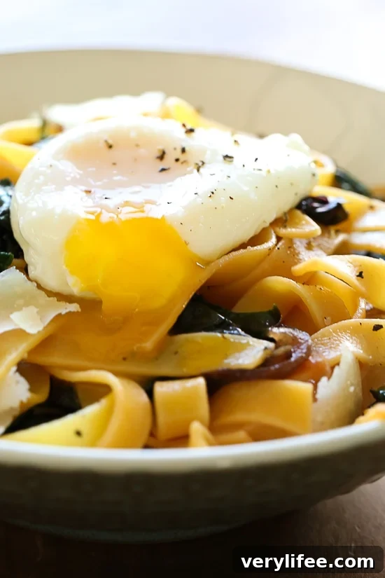 Fettuccini with Winter Greens and Poached Egg is an easy, pantry dinner recipe that take under 15 minutes and perfect if you're on a budget.