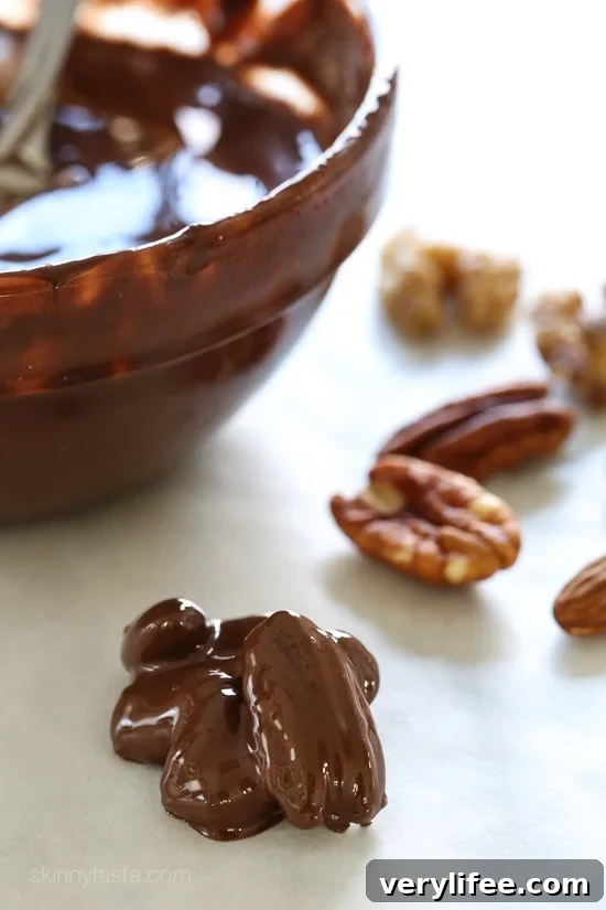 Almonds, pecans and walnuts are dipped in dark melted chocolate and finished with a touch of sea salt for the tastiest Holiday treats!