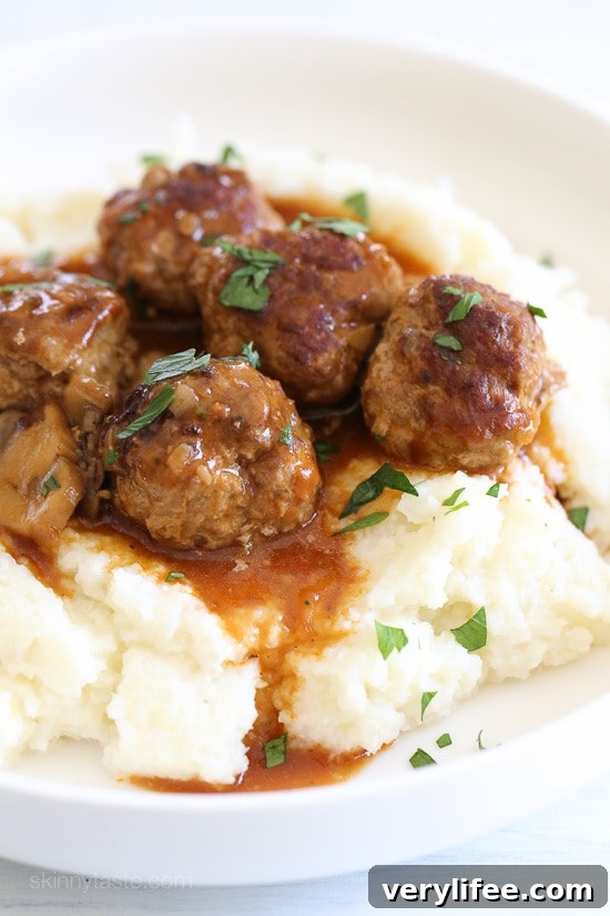 These beefy meatballs are cooked in a mushroom gravy and lightened up by using half ground turkey and half lean ground beef.