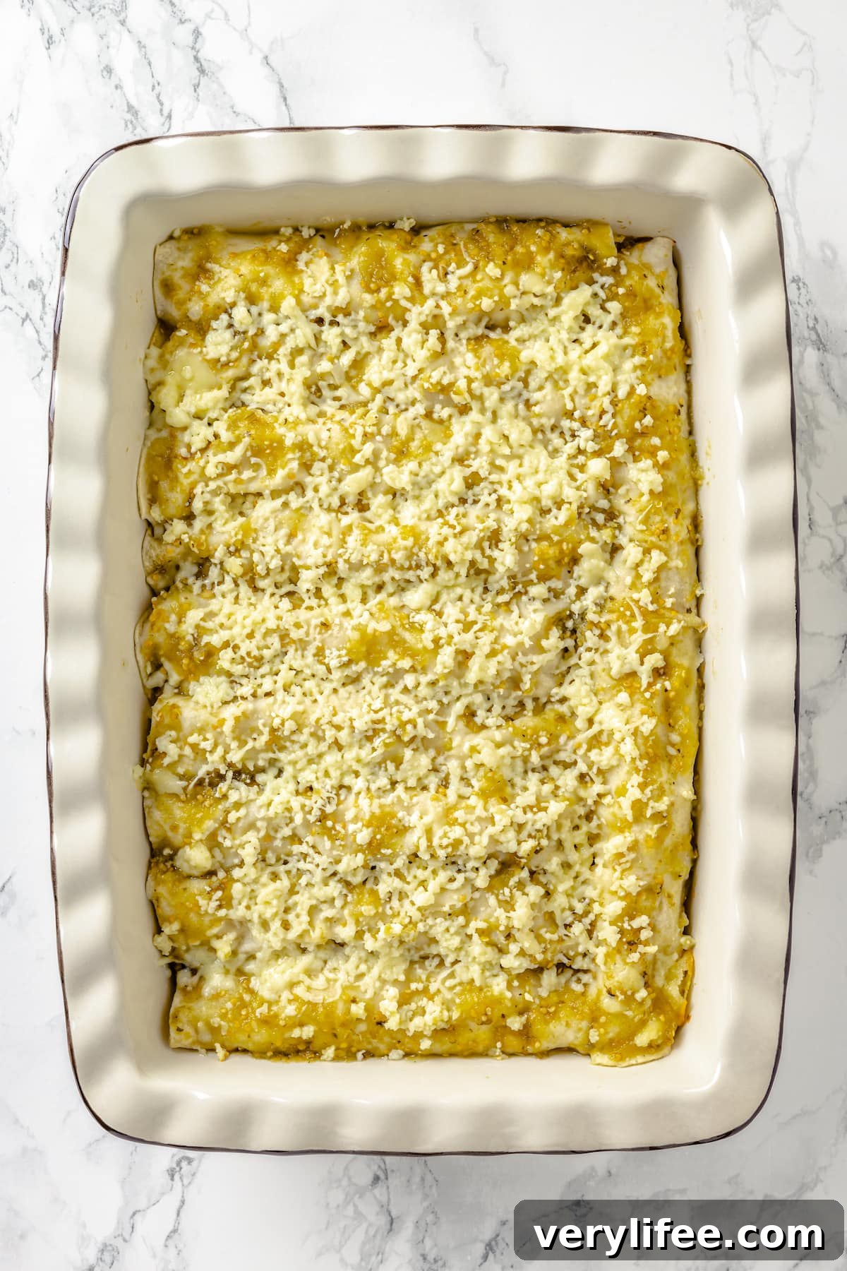 A casserole dish of chicken green enchiladas