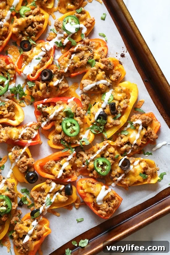 Loaded mini bell pepper nachos – game changer!! These low-carb nachos are loaded with turkey taco meat, cheese and all your favorite nacho toppings!