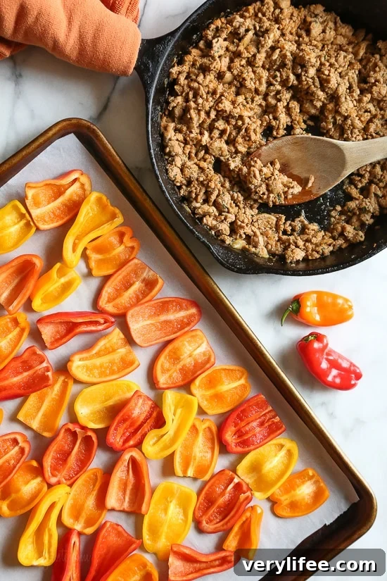 Loaded mini bell pepper nachos – game changer!! These low-carb nachos are loaded with turkey taco meat, cheese and all your favorite nacho toppings!