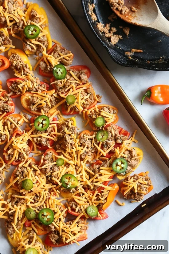 Loaded mini bell pepper nachos – game changer!! These low-carb nachos are loaded with turkey taco meat, cheese and all your favorite nacho toppings!