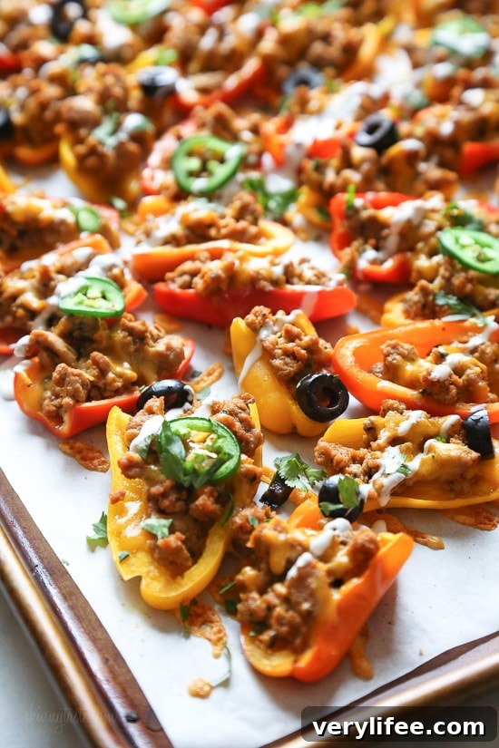 Loaded mini bell pepper nachos – game changer!! These low-carb nachos are loaded with turkey taco meat, cheese and all your favorite nacho toppings!