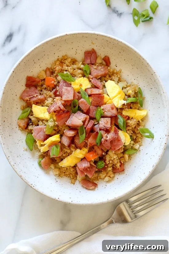 Cauliflower Fried "Rice" with Leftover Ham is a great way to use up that leftover ham from the Holidays, without the calories and carbs you may have over-indulged on.