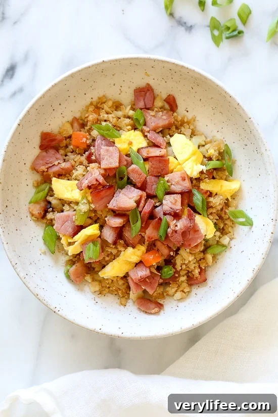 Cauliflower Fried "Rice" with Leftover Ham is a great way to use up that leftover ham from the Holidays, without the calories and carbs you may have over-indulged on.