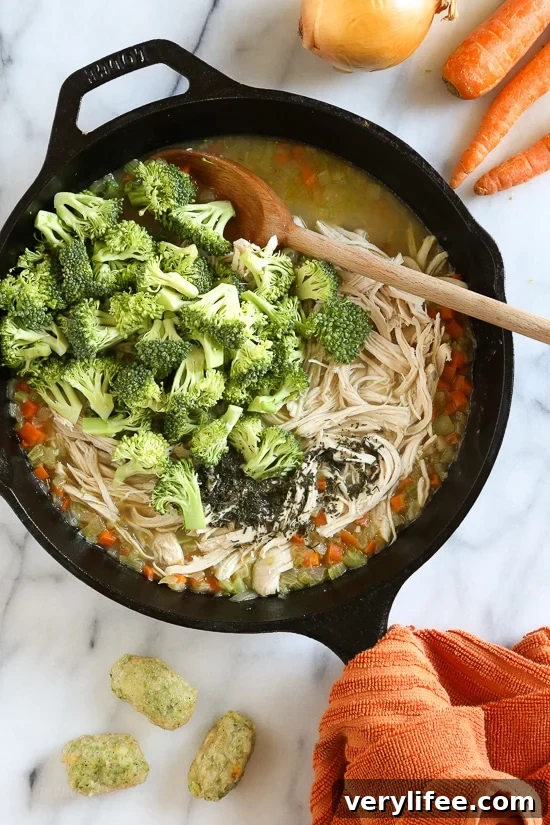 Skillet Chicken and Broccoli Veggie Tot Pie is the ultimate fast and easy, family-friendly, one-pan comfort dish! Made in a skillet with chicken breast, celery, carrots, and broccoli, then finished in the oven with broccoli and cheese veggie tots.
