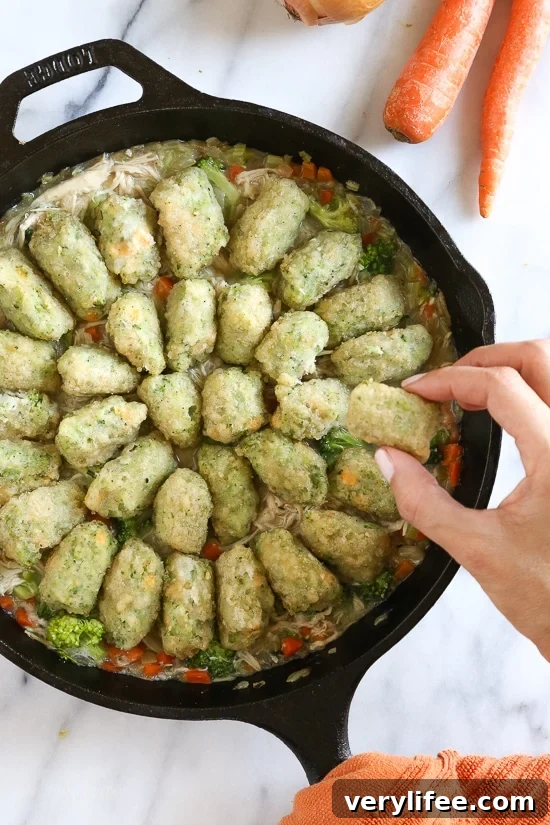 Skillet Chicken and Broccoli Veggie Tot Pie is the ultimate fast and easy, family-friendly, one-pan comfort dish! Made in a skillet with chicken breast, celery, carrots, and broccoli, then finished in the oven with broccoli and cheese veggie tots.