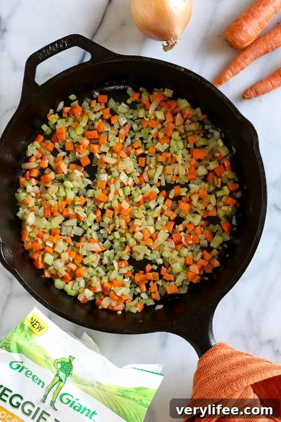 Skillet Chicken and Broccoli Veggie Tot Pie is the ultimate fast and easy, family-friendly, one-pan comfort dish! Made in a skillet with chicken breast, celery, carrots, and broccoli, then finished in the oven with broccoli and cheese veggie tots.