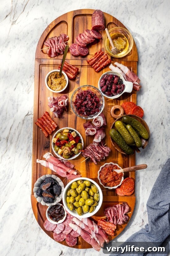 Charcuterie board in process, with bowls and meats.