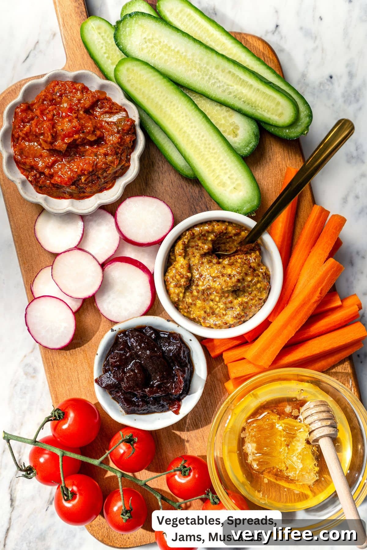 Vegetables, spreads, jams, and mustard for charcuterie board.