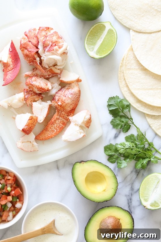 Three lobster tacos with garnishes