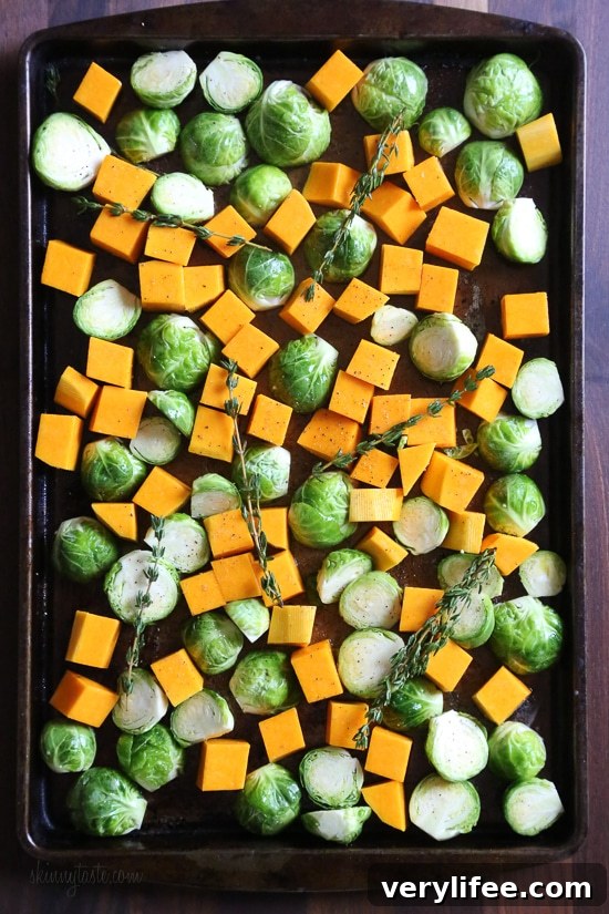 Roasted Brussels Sprouts and Butternut Squash are tossed with olive oil, salt and pepper for an easy Fall side dish! Simply place them on a sheet pan and bake until tender and the Brussels are slightly charred on the edges. 