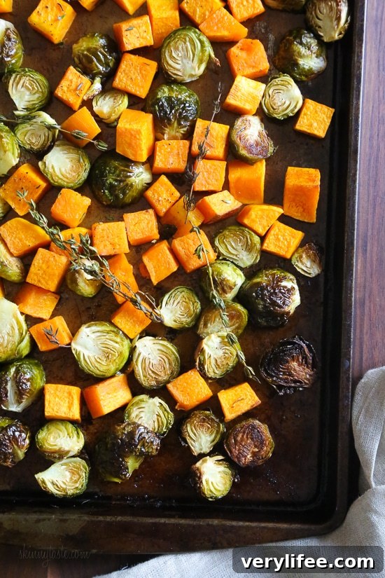 Roasted Brussels Sprouts and Butternut Squash are tossed with olive oil, salt and pepper for an easy Fall side dish! Simply place them on a sheet pan and bake until tender and the Brussels are slightly charred on the edges.
