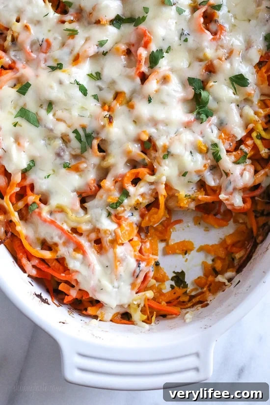 Spiralized Winter Vegetable Gratin with Parmesan and Herbs 2 Spiralized veggie gratin in a white dish.