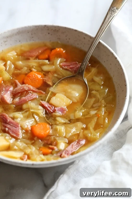 If you’re looking for leftover ham recipes, you’ll love this leftover ham bone and potato soup! It’s hearty, flavorful, and easy to make too. Bowl of ham bone soup with potatoes and cabbage