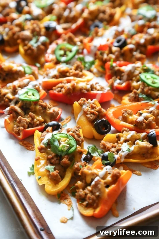 Loaded mini bell pepper nachos – game changer!! These low-carb nachos are loaded with turkey taco meat, cheese and all your favorite nacho toppings!