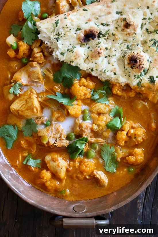 I've created a lightened up, dairy-free Chicken Tikka Masala with Cauliflower and Peas in the Instant Pot to satisfy my craving for Indian food! This mild curry is made with boneless chicken thighs cooked in a tomato base, with lots of spices and coconut milk. You can serve this with garlic naan or basmati rice on the side (cauliflower rice would work too to keep it low carb!)
