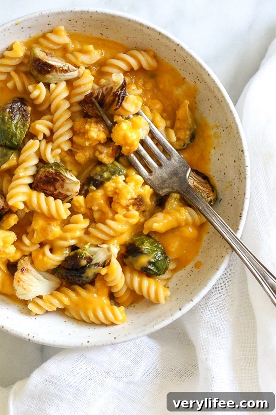 It's October, so Pumpkin Mac and Cheese with Roasted Cauliflower and Brussels Sprouts is a must for the Fall! Using pumpkin puree makes a creamy light cheese sauce, without having to add cream or too much cheese. You can make your own pumpkin puree or use organic canned pumpkin to make it faster!