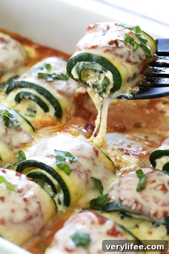 Zucchini Rollatini is low-carb and delicious! Made with strips of grilled zucchini stuffed with a basil-cheese filling, then rolled and topped with marinara, mozzarella and baked in the oven until the cheese is hot and melted.