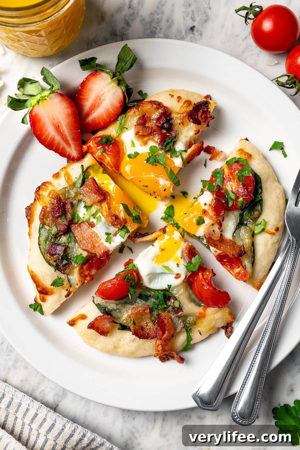 High-Protein Breakfast Pizza Recipe 14 Breakfast pizza on plate with runny yolk, sliced into quarters.