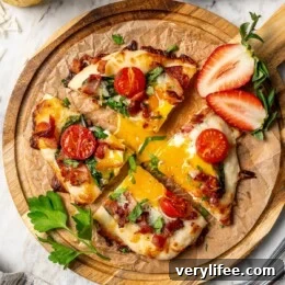 High-Protein Breakfast Pizza Recipe 4 Sliced breakfast pizza topped with runny egg.