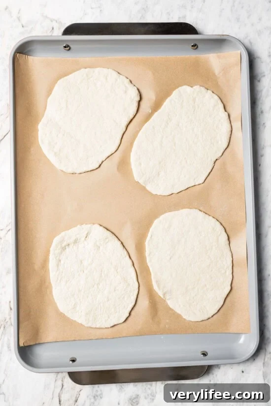 High-Protein Breakfast Pizza Recipe 8 Dough for breakfast pizzas on parchment-lined pan.