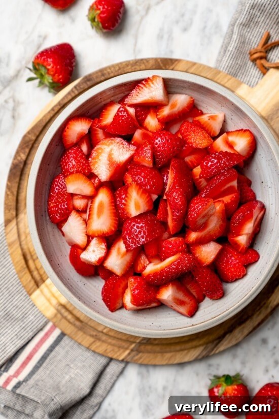 Homemade Strawberry Crisp Recipe with Oat Streusel 5 Fresh quartered strawberries in bowl