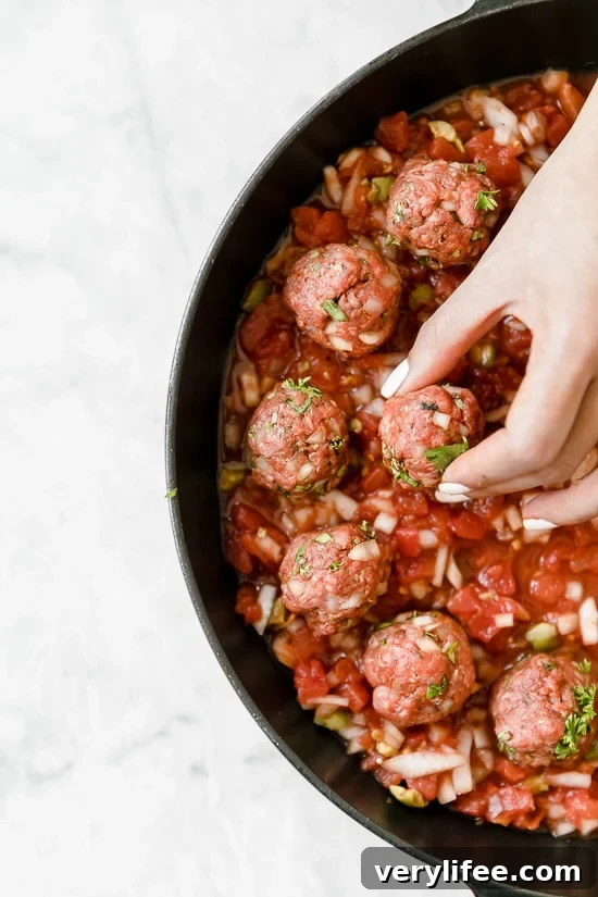 Moroccan Kefta Meatballs made with tomatoes and olives are simmered together in the slow cooker or Instant Pot in this easy and exotic Moroccan dinner.