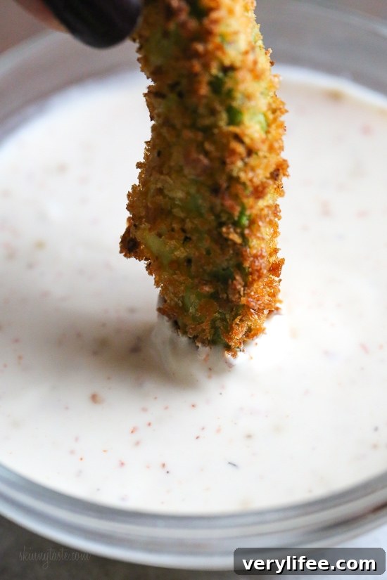 Crispy baked avocado fries coated with panko breadcrumbs with a lime dipping sauce. So fast and easy to make in the oven or air fryer!