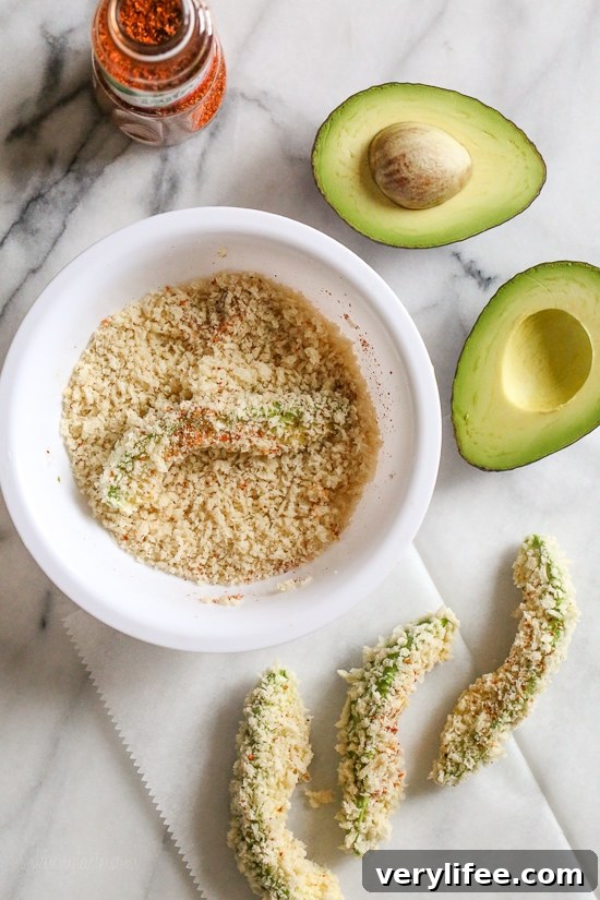 Crispy baked avocado fries coated with panko breadcrumbs with a lime dipping sauce. So fast and easy to make in the oven or air fryer!