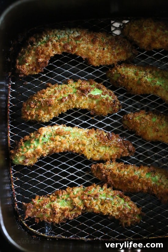 Crispy baked avocado fries coated with panko breadcrumbs with a lime dipping sauce. So fast and easy to make in the oven or air fryer!