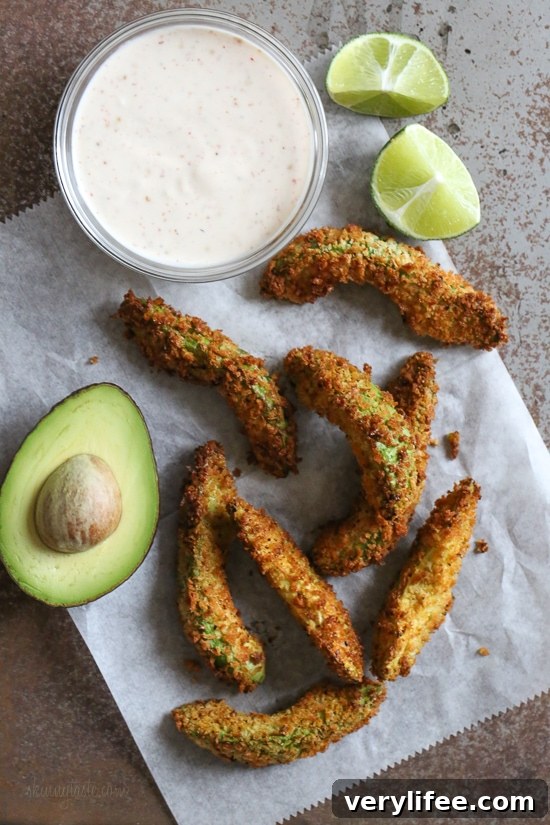 Crispy baked avocado fries coated with panko breadcrumbs with a lime dipping sauce. So fast and easy to make in the oven or air fryer!