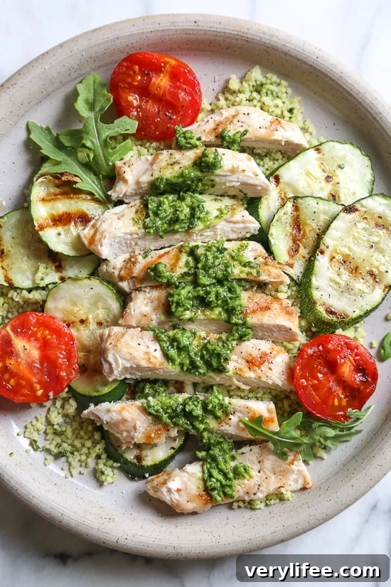 Grilled chicken, zucchini and tomatoes topped with a light spinach-arugula basil pesto served over couscous.