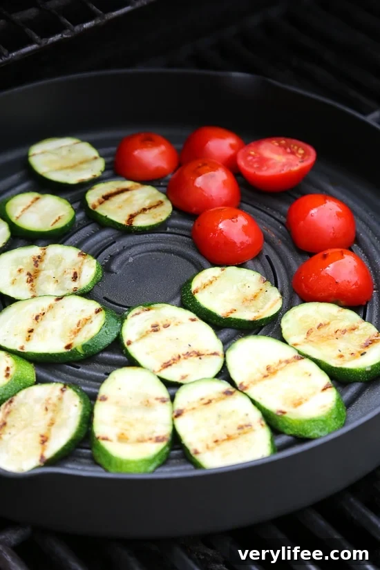 Grilled chicken, zucchini and tomatoes topped with a light spinach-arugula basil pesto served over couscous.