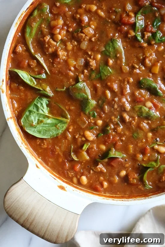 Savory Turkey and Pumpkin Chili Recipe 5 Turkey Pumpkin Chili is the perfect Fall dish made with ground turkey, tomatoes, canned pumpkin, white beans and spinach.