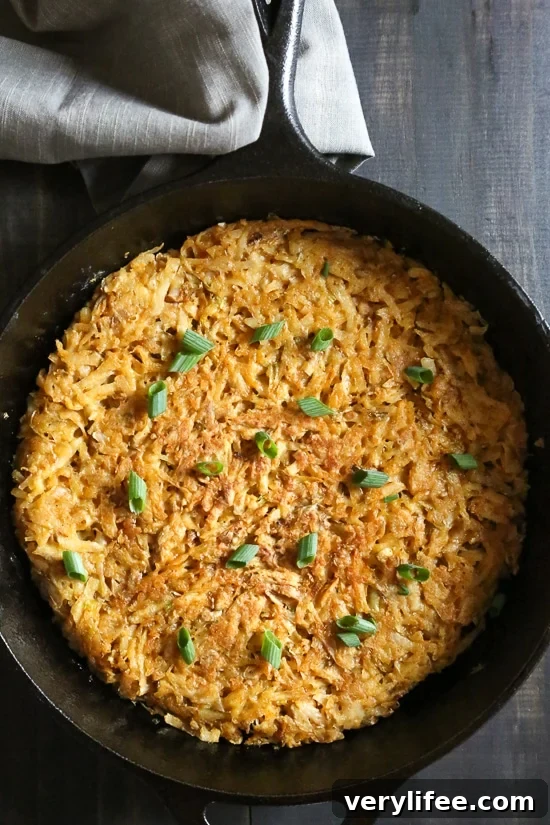 Overhead view of crispy hash browns in cast iron skillet