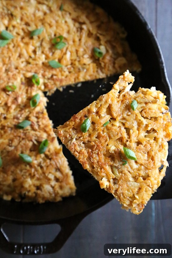 Lifting wedge of hash browns from skillet