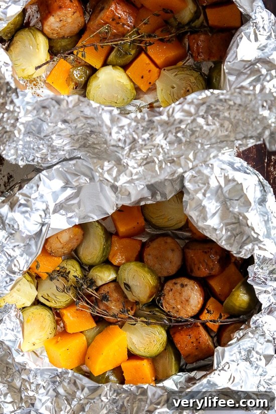Spicy Sausage Foil Packets with Brussels Sprouts and Butternut 3 Spicy Sausage and Brussels sprouts with butternut squash in foil packets ready to bake.