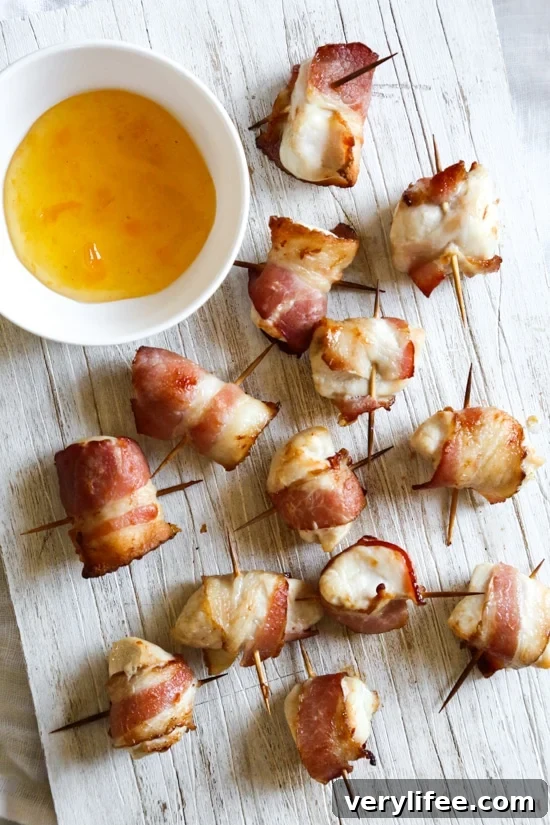 Bacon wrapped chicken bites are the easiest appetizer, made with just TWO ingredients. Using the air fryer, the bacon comes out crisp on the outside, and the chicken juicy and tender inside.