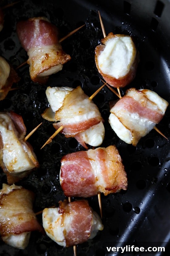 Bacon wrapped chicken bites are the easiest appetizer, made with just TWO ingredients. Using the air fryer, the bacon comes out crisp on the outside, and the chicken juicy and tender inside.